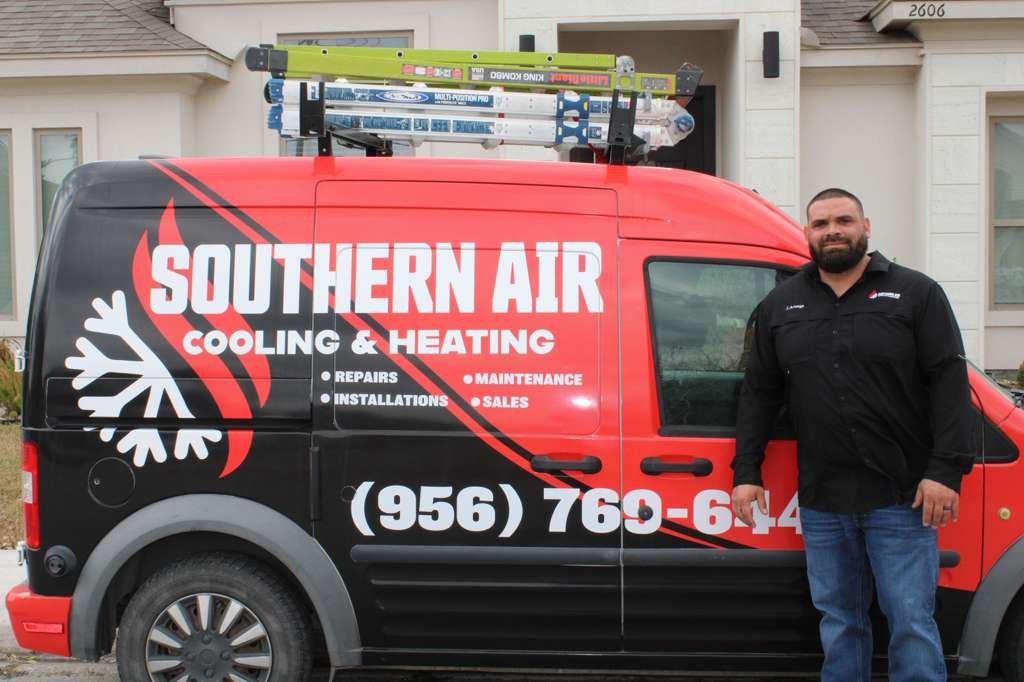 Justin Arteaga, owner of Southern Air Cooling & Heating, standing beside his branded service van